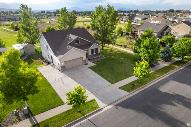 2485 South 1100th Street West Logan, UT 84321 - Photo 42 of 53 Two-story property featuring a front-facing attached garage, stone and siding exterior accents, and a paved driveway