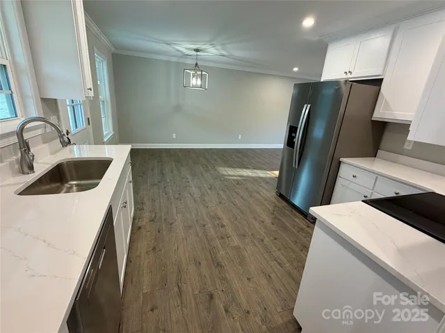 a kitchen with a sink and refrigerator