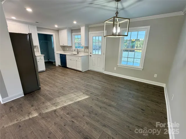 a view of kitchen with refrigerator microwave and wooden floor