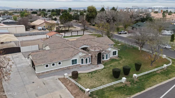 an aerial view of a house with garden space and ocean view