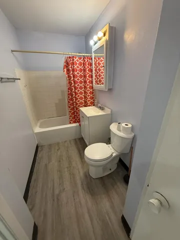 a bathroom with a toilet and a shower