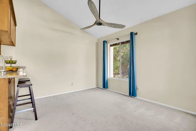 a view of kitchen with furniture and a window