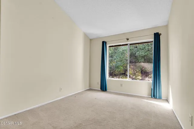 a bathroom with a granite countertop sink a toilet and a mirror
