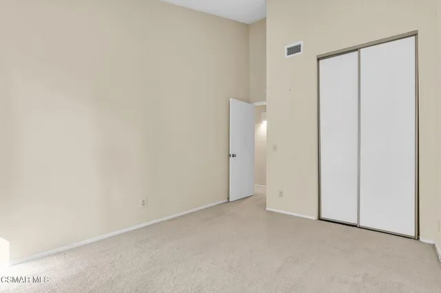 a en suite bathroom with a granite countertop sink and a mirror