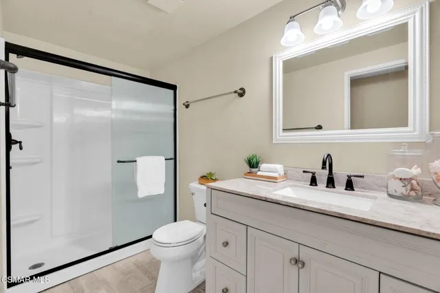 a spacious bedroom with a bed and a potted plant