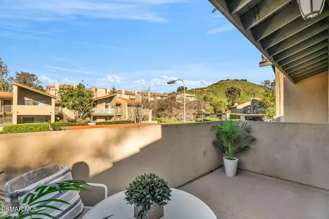 a outdoor space with a bench and a potted plant
