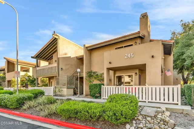 a view of a house with a bench in patio