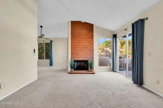 a view of a livingroom with an empty space and a fireplace