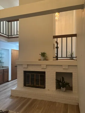 a living room with furniture a fireplace and a wooden floor
