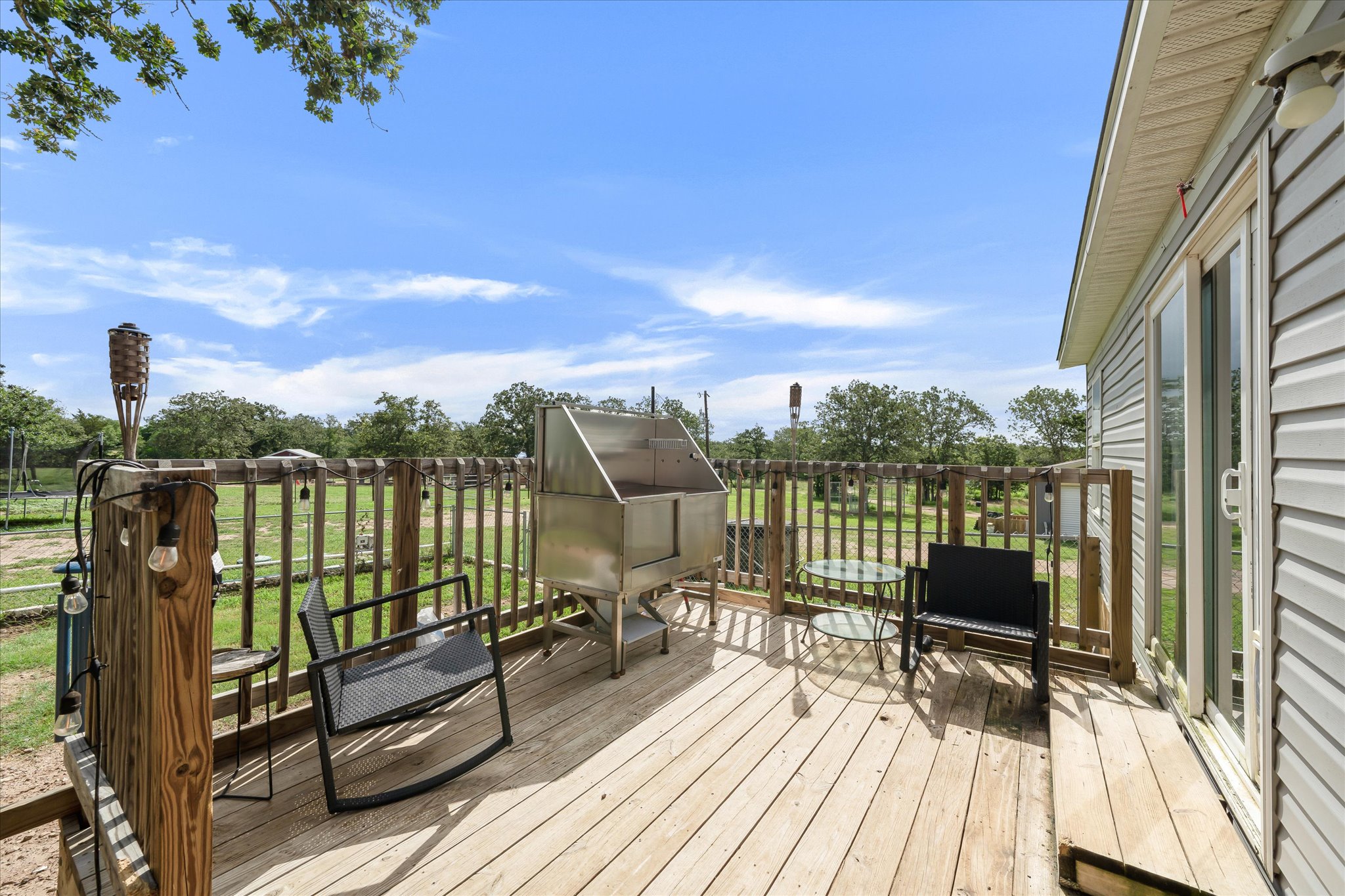 2755 Washburn Road Luling, TX 78648 - Photo 33 of 40 A spacious wooden deck provides ample outdoor living space, perfect for enjoying tranquil views.