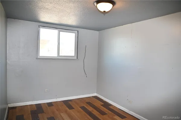 a kitchen with stainless steel appliances a refrigerator and wooden floor