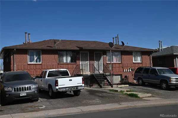 a front view of a house with parking space