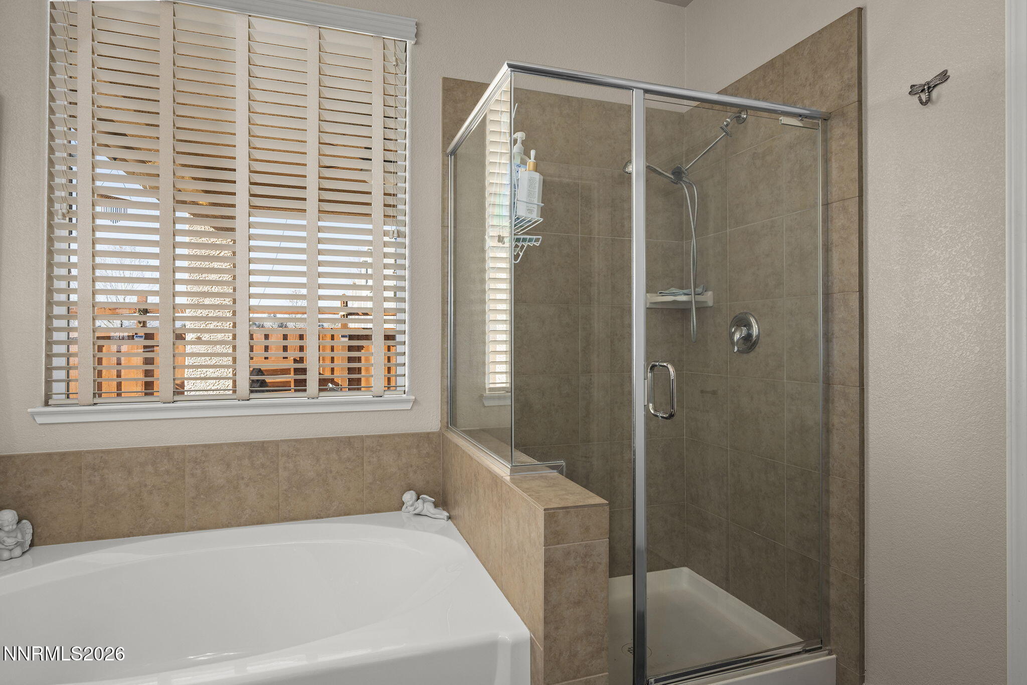 6787 Centaurus Drive Sparks, NV 89436 - Photo 14 of 39 a bathroom with a bathtub and shower