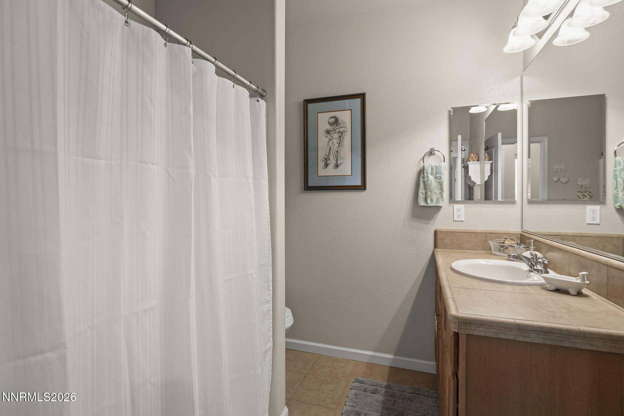 6787 Centaurus Drive Sparks, NV 89436 - Photo 17 of 39 a bathroom with a sink and a mirror