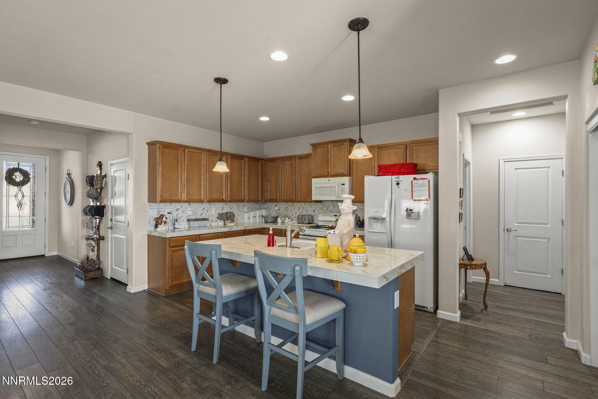 6787 Centaurus Drive Sparks, NV 89436 - Photo 6 of 39 a kitchen with refrigerator and wooden floor