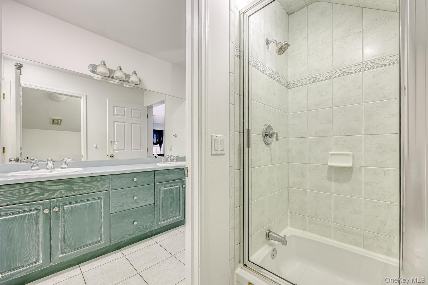 22 Golden Road Suffern, NY 10901 - Photo 24 of 41 Full bath featuring light tile patterned floors, double vanity, and washtub / shower combination