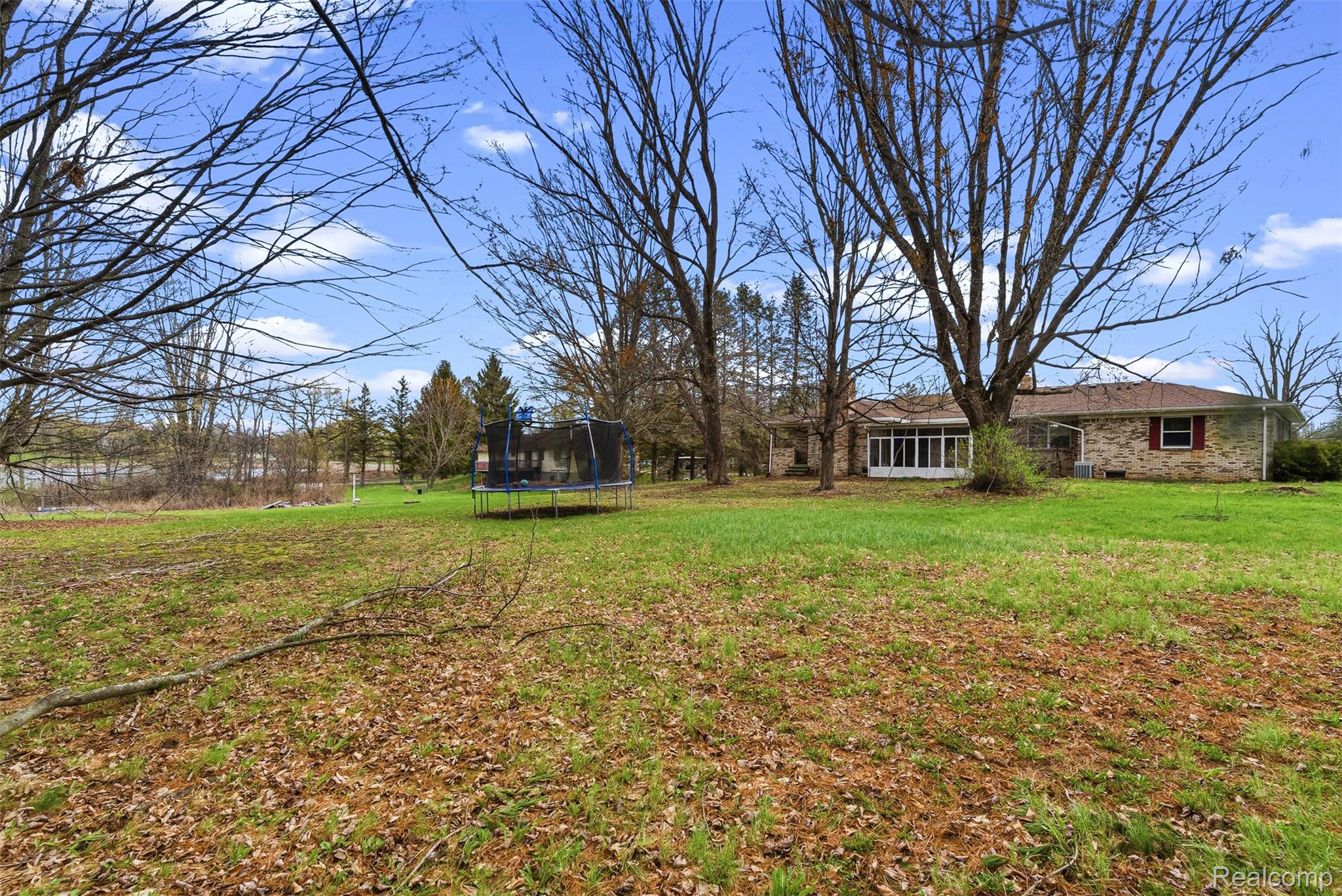 3432 South State Road Davison, MI 48423 - Photo 53 of 58 View of grassy yard with a trampoline