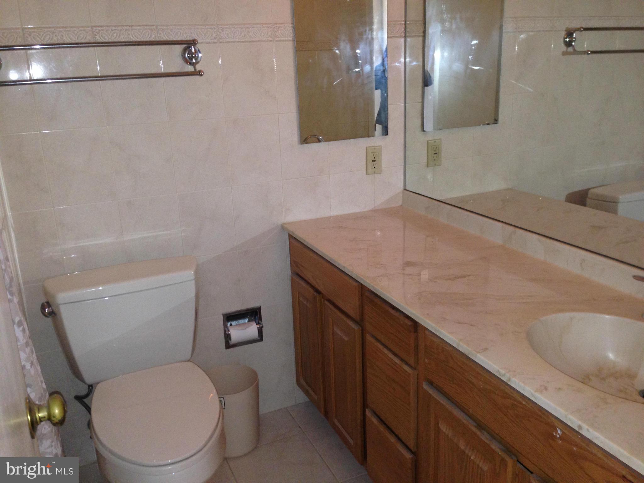 1616 Hopefield Road Silver Spring, MD 20905 - Photo 18 of 22 a bathroom with a granite countertop toilet sink and mirror
