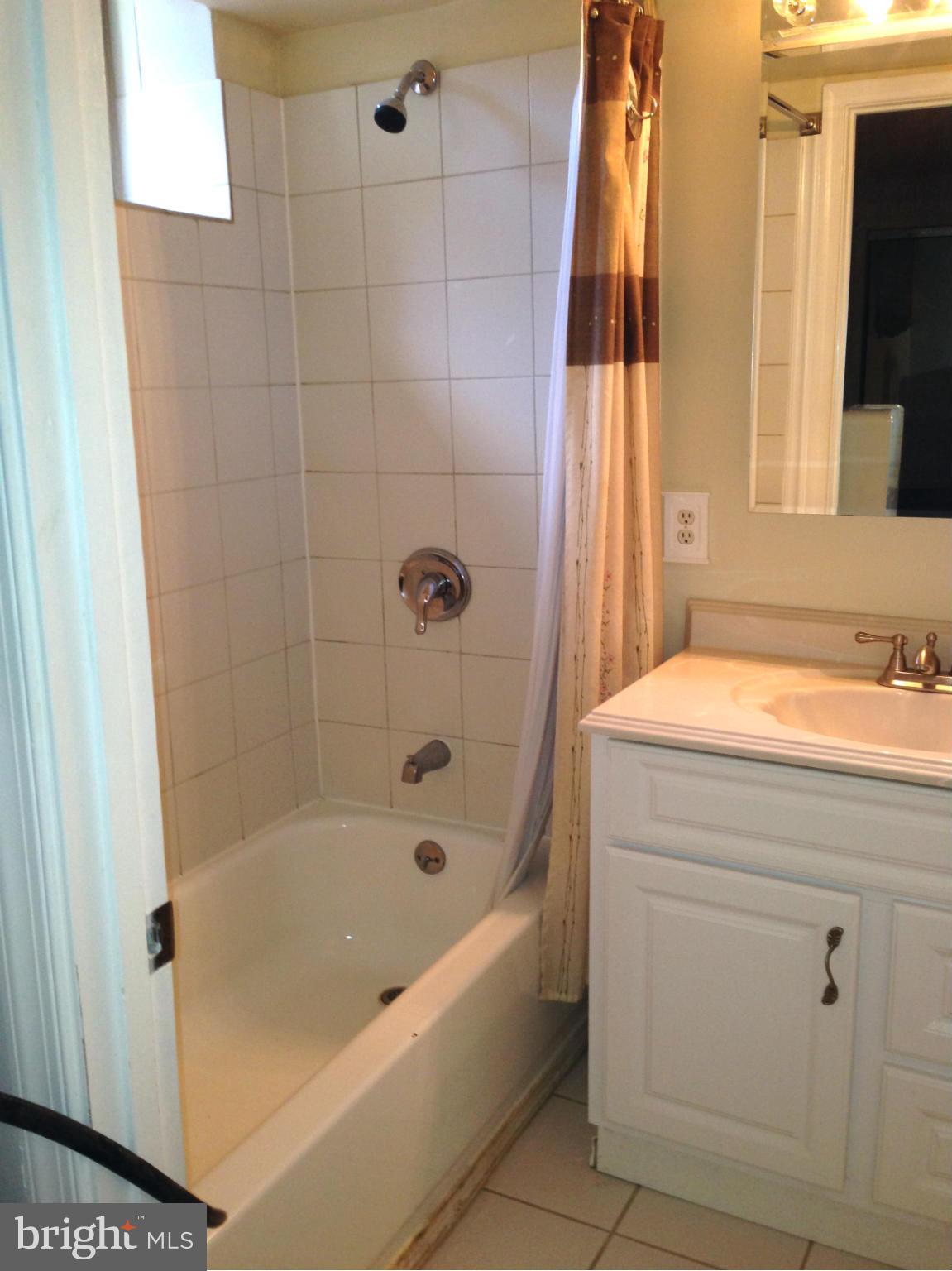 1616 Hopefield Road Silver Spring, MD 20905 - Photo 20 of 22 a bathroom with a bath tub and a shower