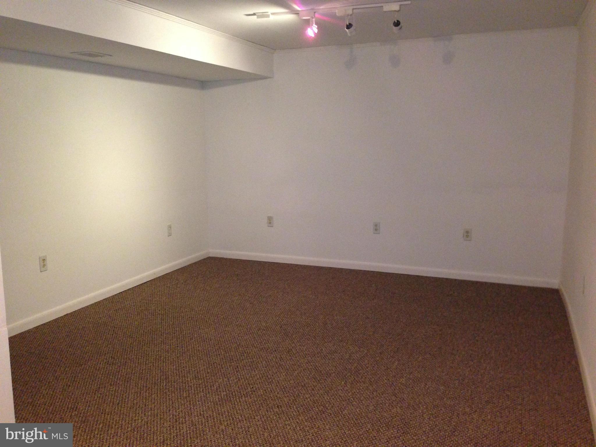 1616 Hopefield Road Silver Spring, MD 20905 - Photo 22 of 22 an empty room with a hard wood floor