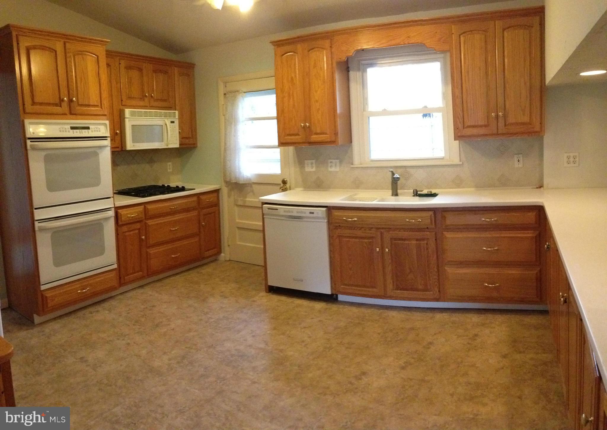 1616 Hopefield Road Silver Spring, MD 20905 - Photo 6 of 22 a kitchen with stainless steel appliances granite countertop a stove a sink and a refrigerator
