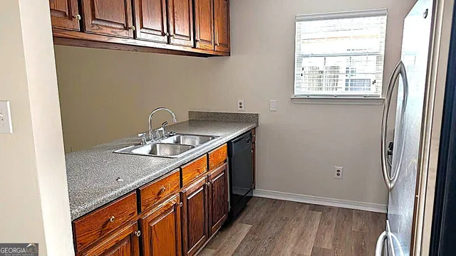 a bathroom with a granite countertop sink and a window