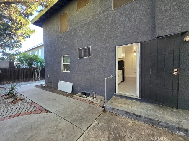 a backyard of a house with table and chairs