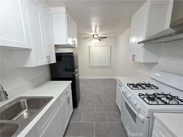 a kitchen that has a sink and a stove