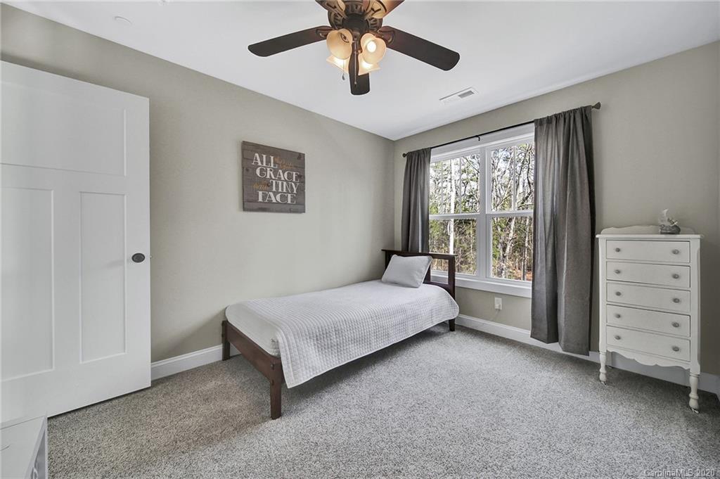 386 East Rebound Road Lancaster, SC 29720 - Photo 22 of 31 a spacious bedroom with a bed and a dresser