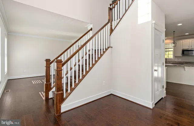 a kitchen with granite countertop white cabinets and a window