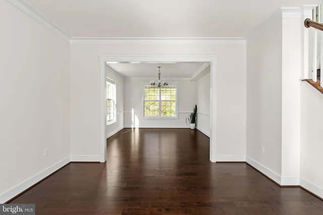 a kitchen with stainless steel appliances granite countertop a refrigerator a sink dishwasher a stove and white cabinets with wooden floor