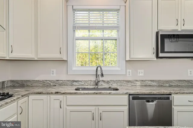 an empty room with a window and a ceiling fan