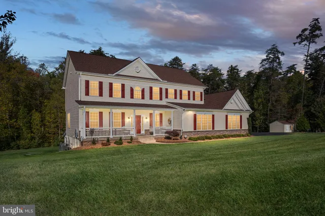 a living room with furniture a fireplace and a large window