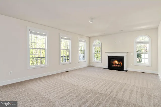 a living room with a large window and cabinet