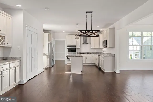 a view of a big yard with plants and large trees