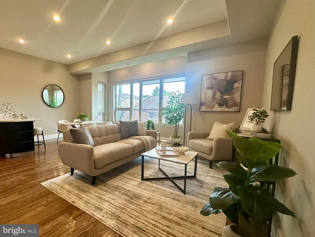 a living room with furniture wooden floor and window