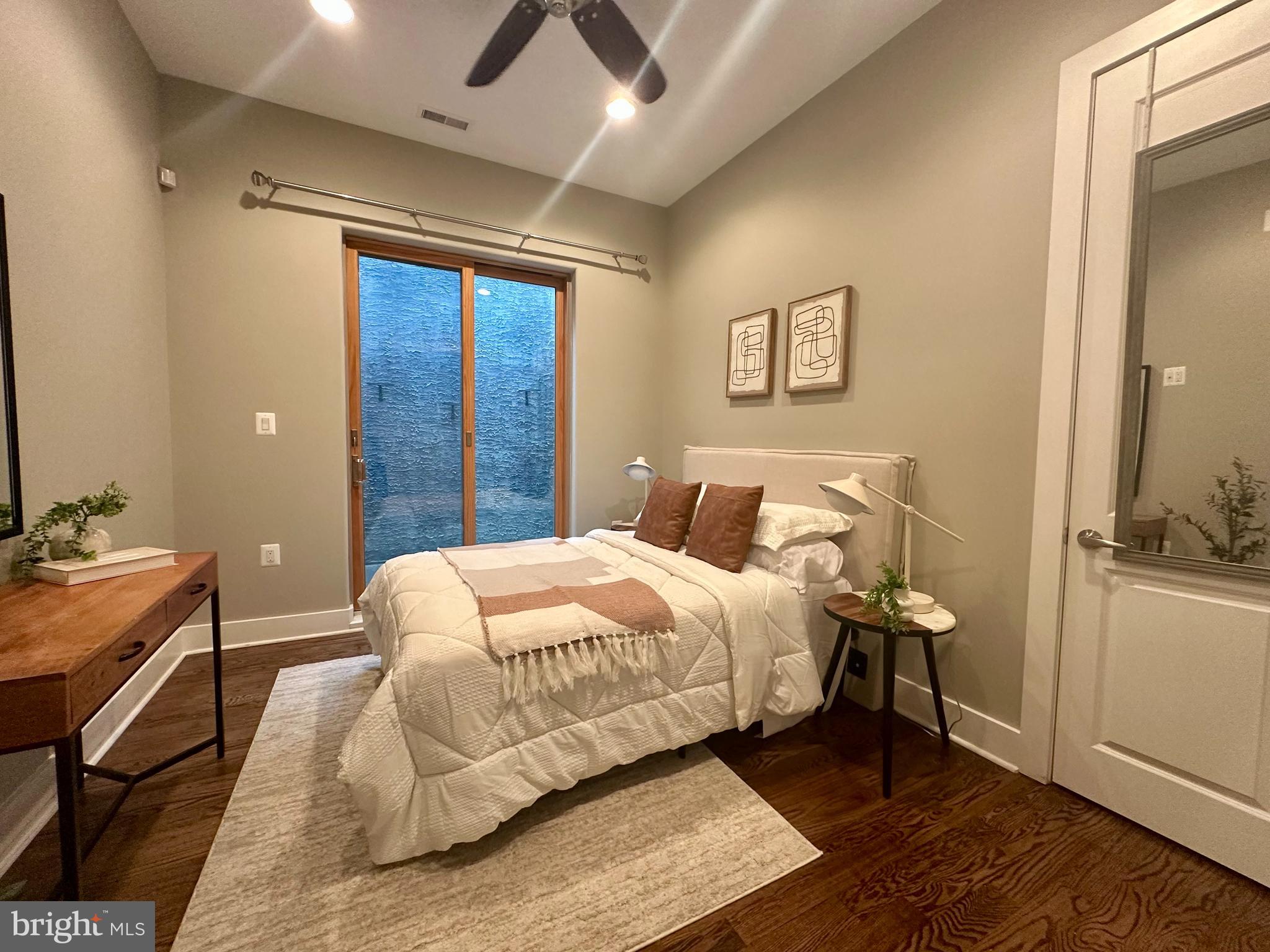 1233 Bainbridge Street, Unit H Philadelphia, PA 19147 - Photo 11 of 24 a bedroom with a bed and a table