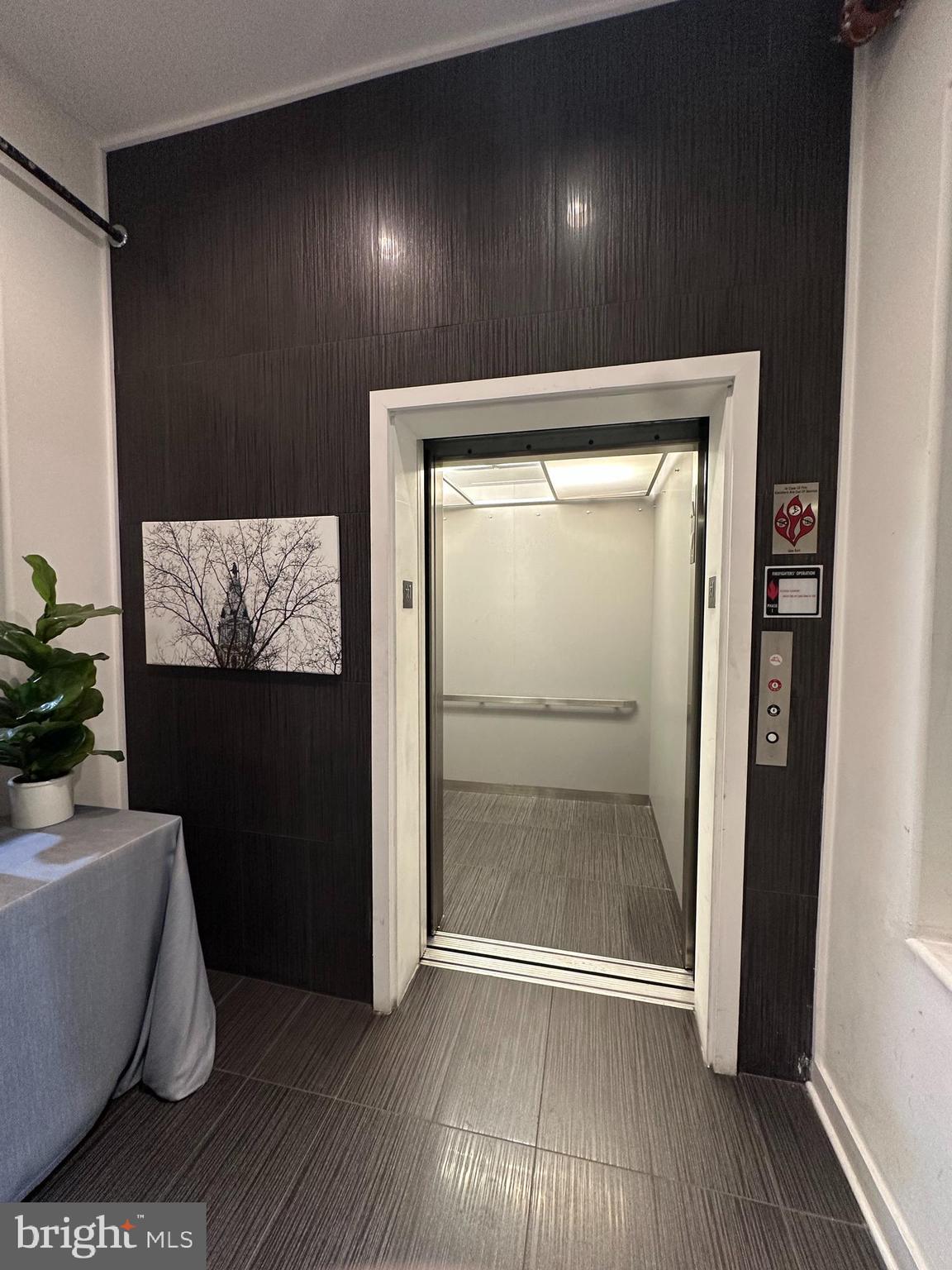 1233 Bainbridge Street, Unit H Philadelphia, PA 19147 - Photo 17 of 24 a view of an empty room with wooden floor and a window
