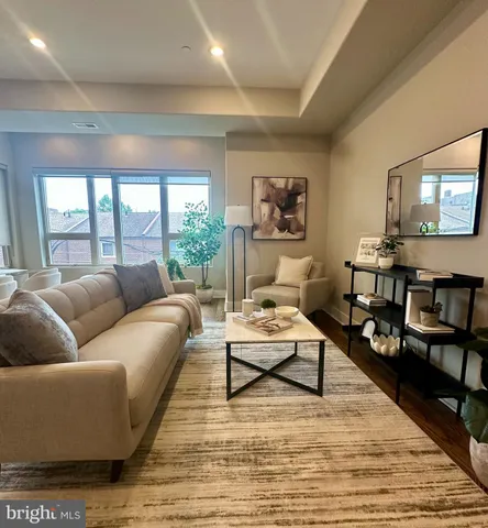 a living room with furniture wooden floor and a flat screen tv