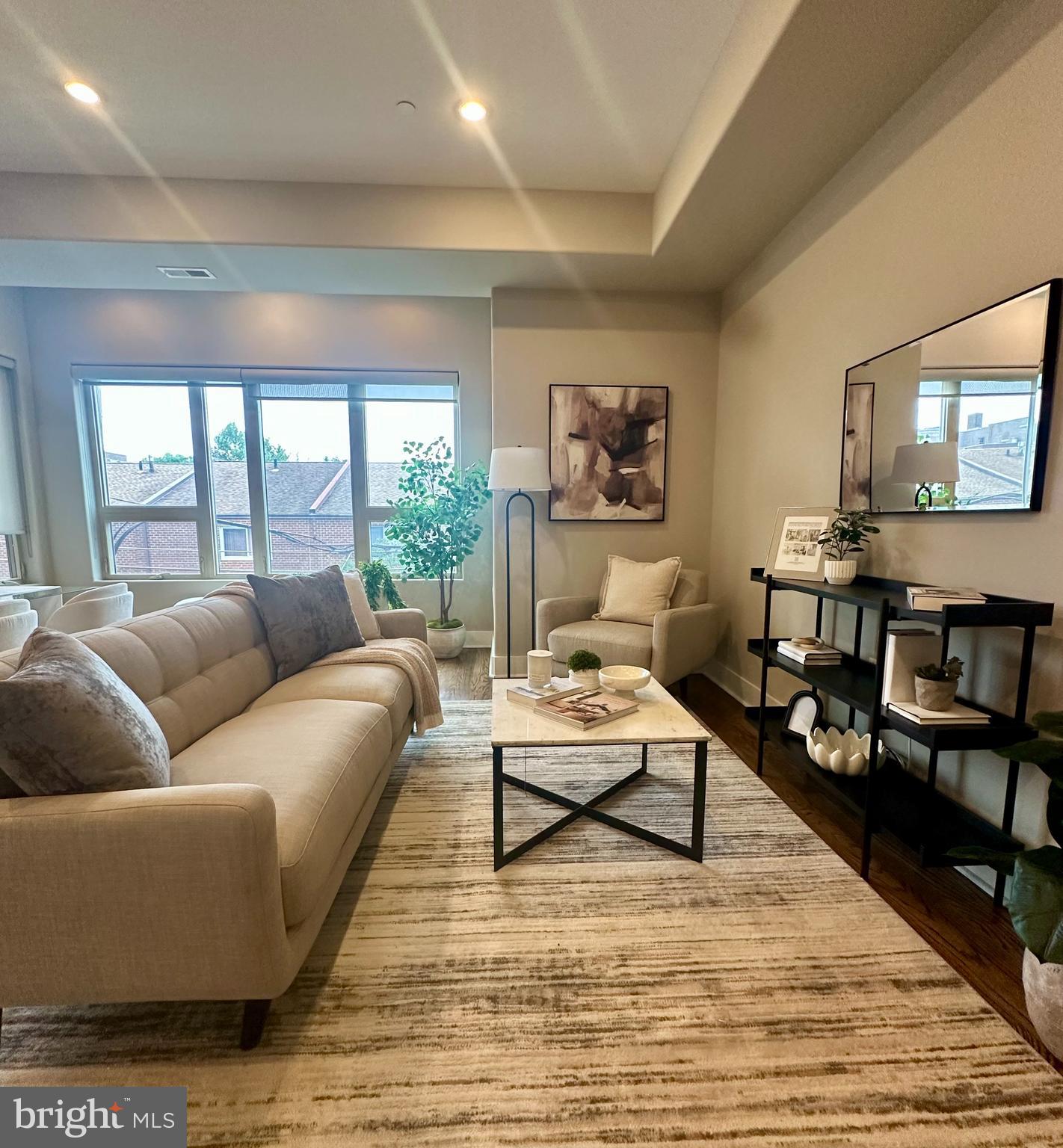 1233 Bainbridge Street, Unit H Philadelphia, PA 19147 - Photo 2 of 24 a living room with furniture wooden floor and a flat screen tv