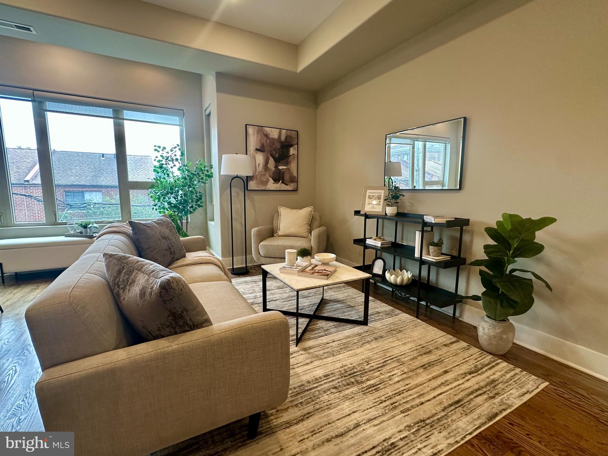 1233 Bainbridge Street, Unit H Philadelphia, PA 19147 - Photo 3 of 24 a living room with furniture wooden floor and a potted plant