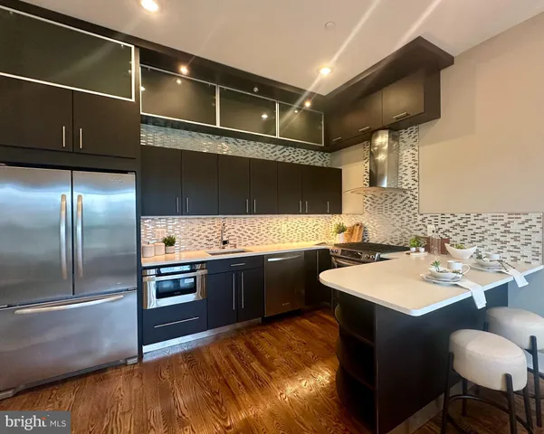a kitchen with a sink appliances and cabinets