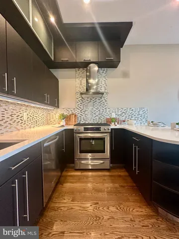 a kitchen with stainless steel appliances granite countertop a stove and a sink