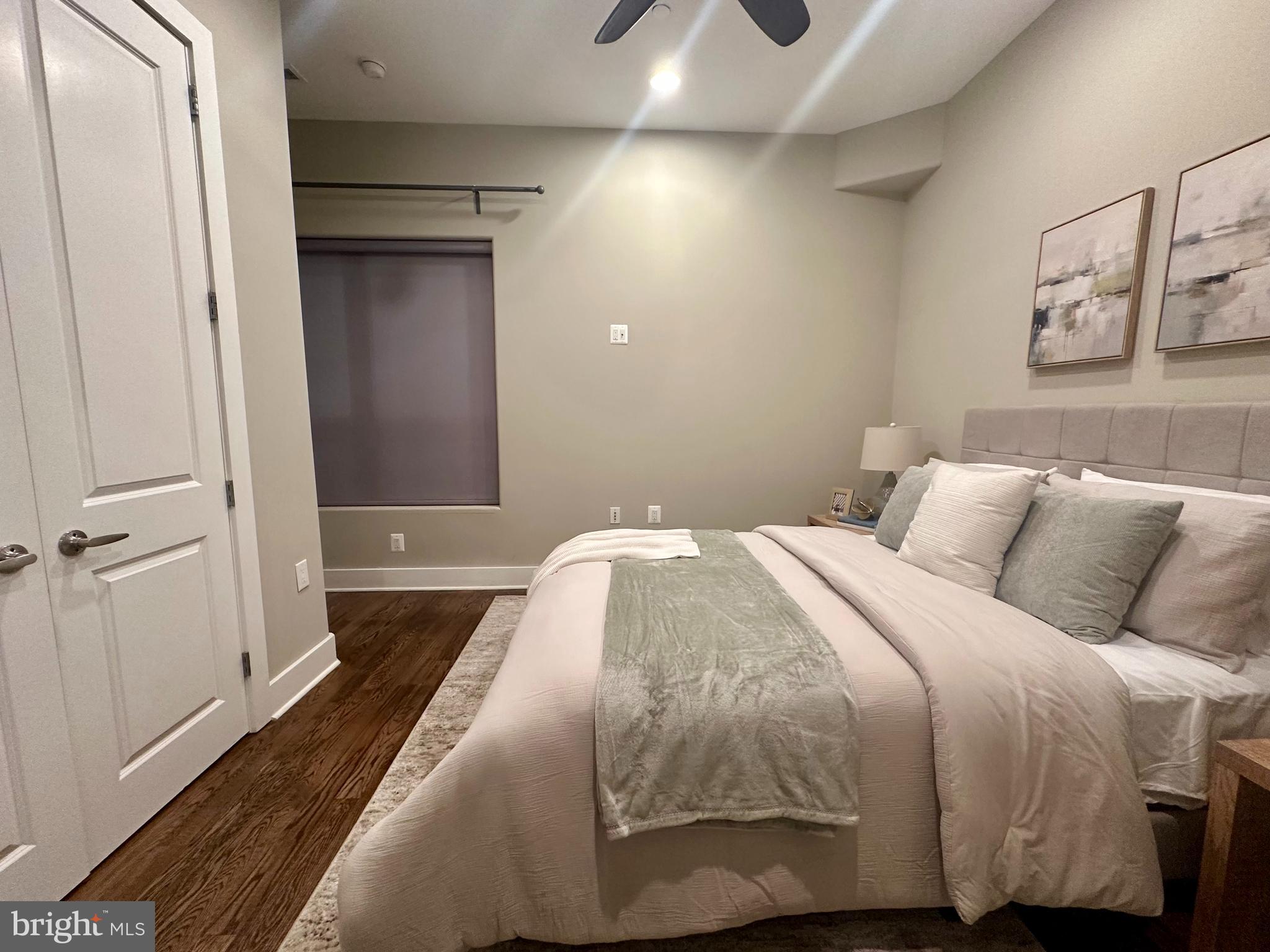 1233 Bainbridge Street, Unit H Philadelphia, PA 19147 - Photo 8 of 24 a bedroom with a bed and a mirror