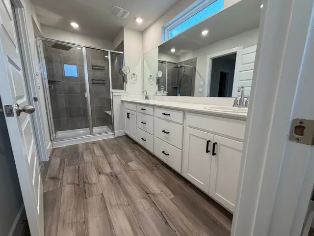 a bathroom with a mirror and a shower
