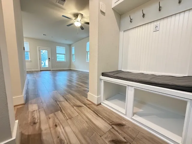 a view of an empty room and window with wooden floor