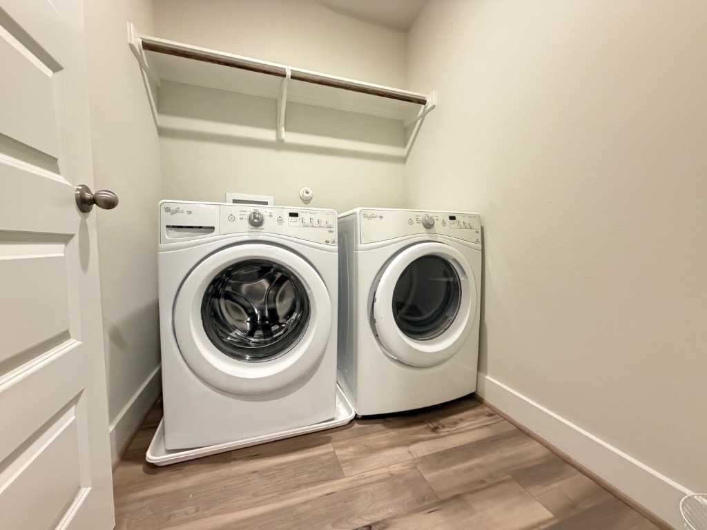 7417 Acela Trail, Unit 231 Austin, TX 78744 - Photo 6 of 15 Washroom with light wood-type flooring and independent washer and dryer