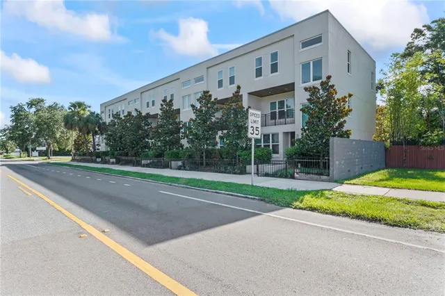 a view of a house with a yard and a street