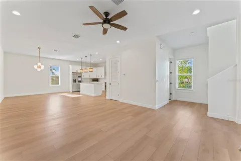 a view of a livingroom with a ceiling fan and window