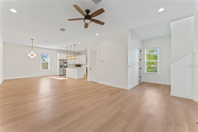 a view of a livingroom with a ceiling fan and window